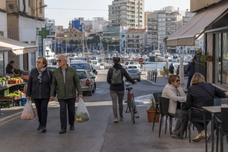 Residents shopping and walking in a Costa Blanca coastal town on a normal weekday